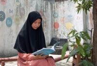 Foto Penulis Kurikulum Falsafah Pendidikan Islam Asmaul Husna sedang membaca Buku