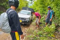 Foto : Warga sedang berusaha membantu mobil yang melintasi jalan Kelawis Mungkin, dusun Kopo  desa Mungkin Kecamatan Orong Telu Sumbawa NTB. (Mulyadi /Suara Utama)