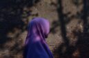 Moslem Woman Silhouette in Old Vintage Brick Wall Background